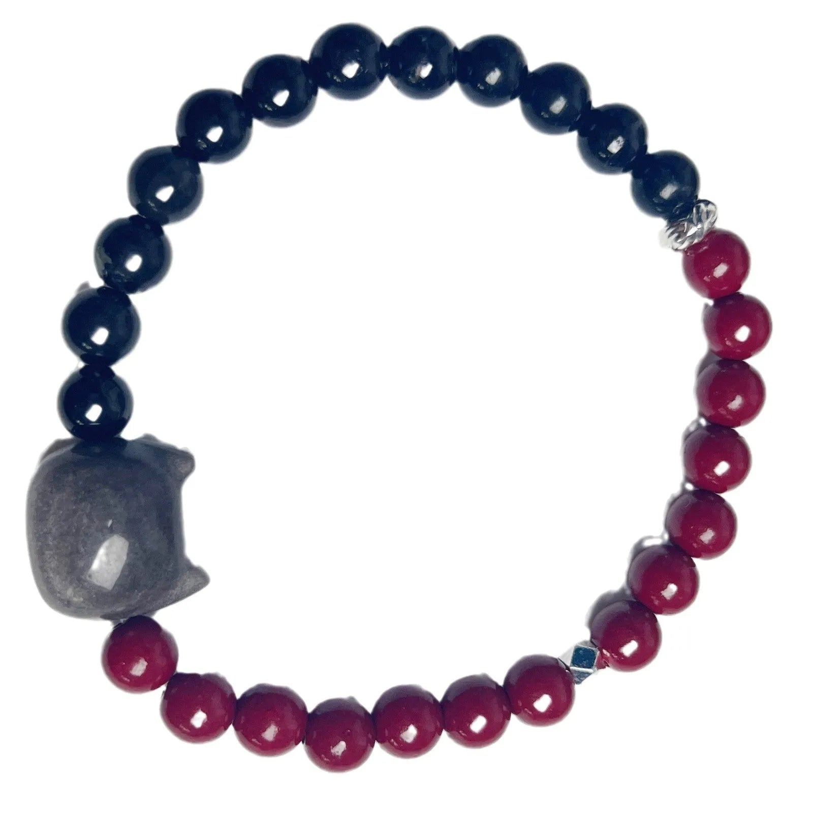 Obsidian-coloured cat charm on a colourful elastic bracelet strap.