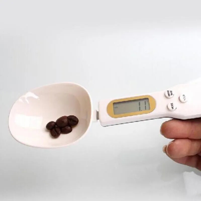 White digital kitchen spoon scale with LCD display showing weight measurement