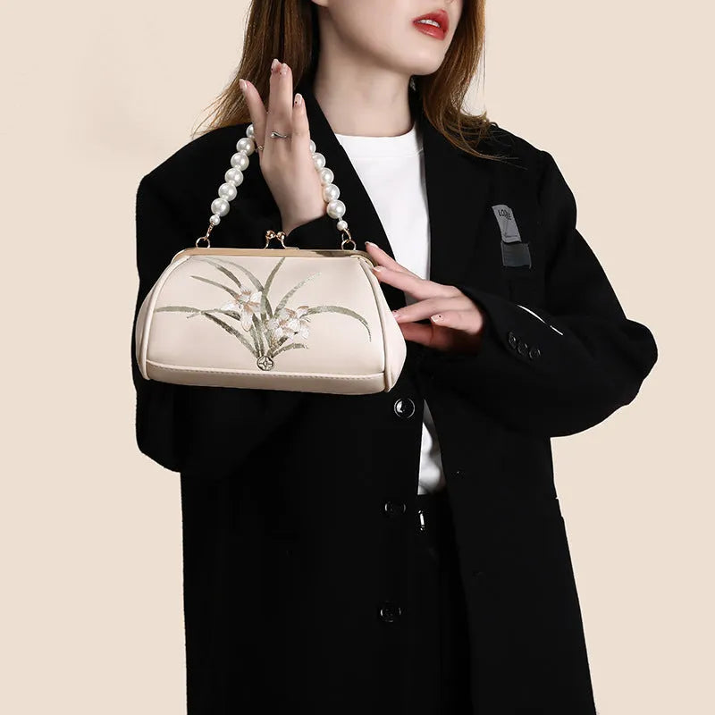 Beige women's shoulder bag with embroidery detail and shell-shaped design in soft PU leather