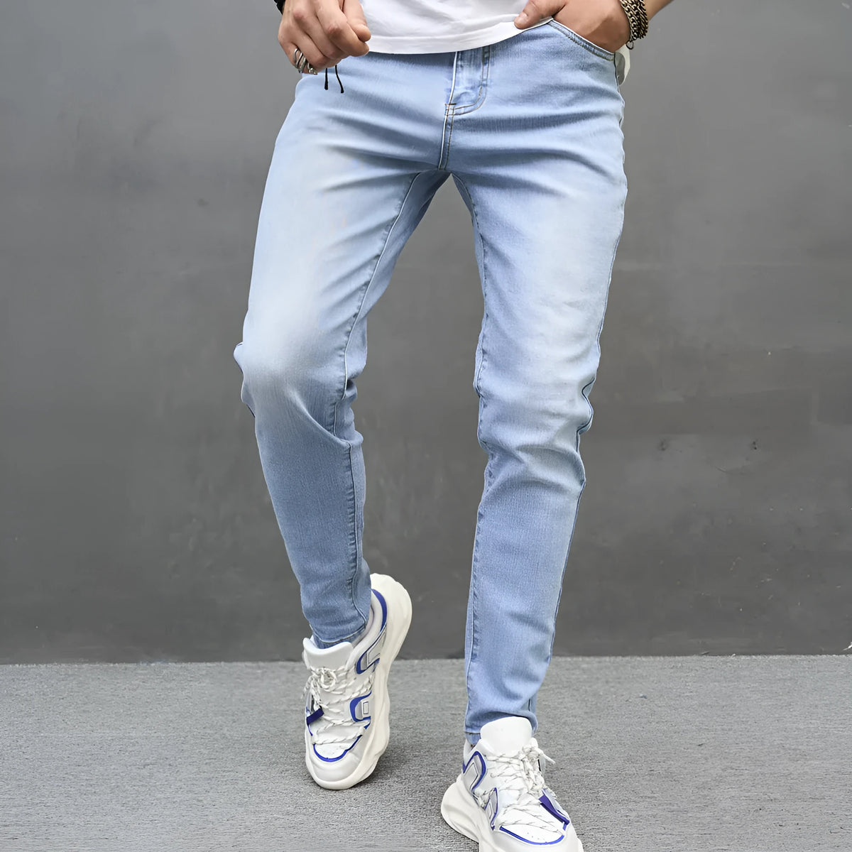 Light blue skinny cotton stretch men's jeans with mid waist and tapered leg on model