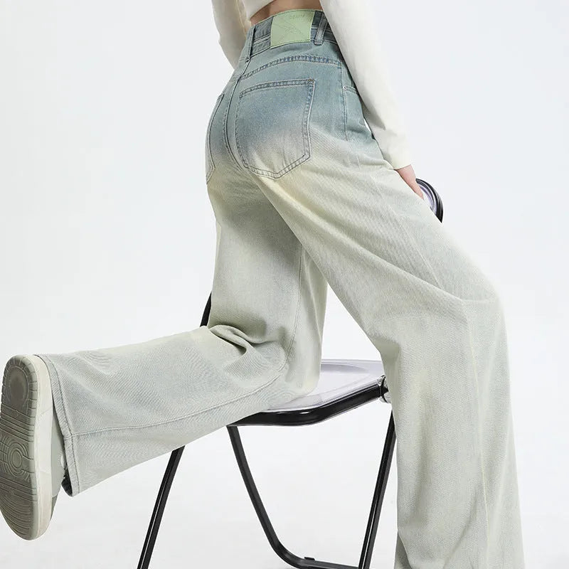 Women's gradient blue straight-leg denim trousers on a hanger.