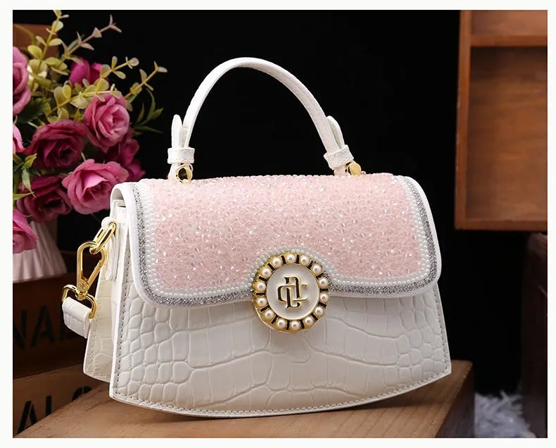 Patent leather diamond portable shoulder bag in black, brown, pink, and red with lock detail and single strap