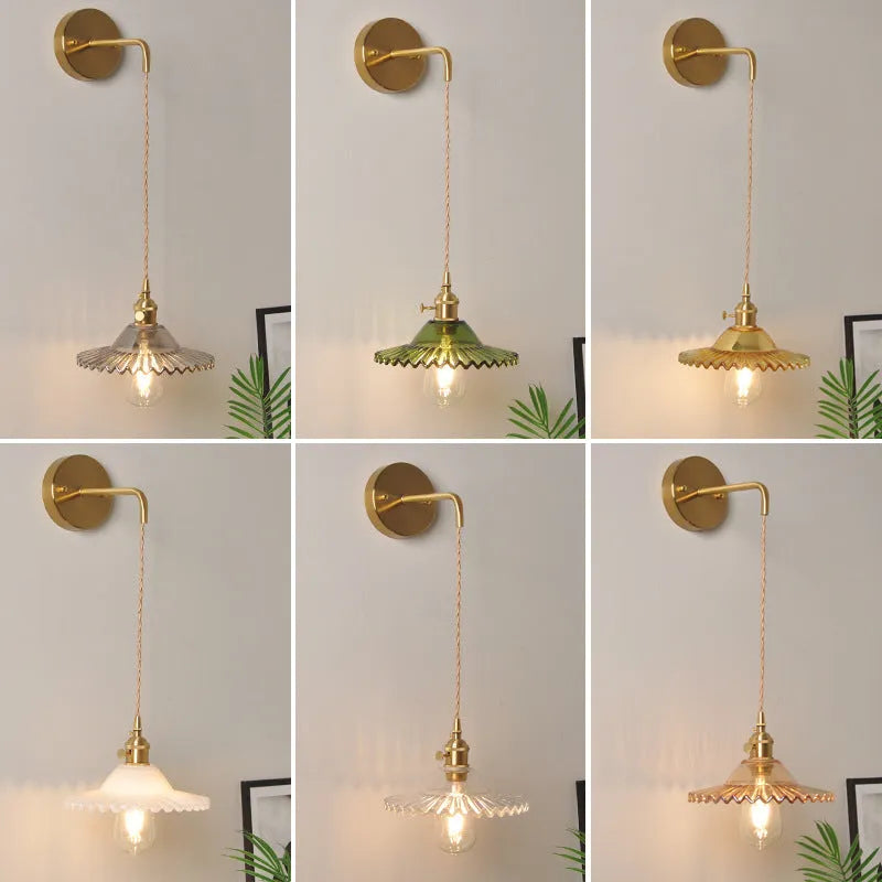 Retro brass-toned copper wall lamp with a white glass lotus shade mounted beside a bed.