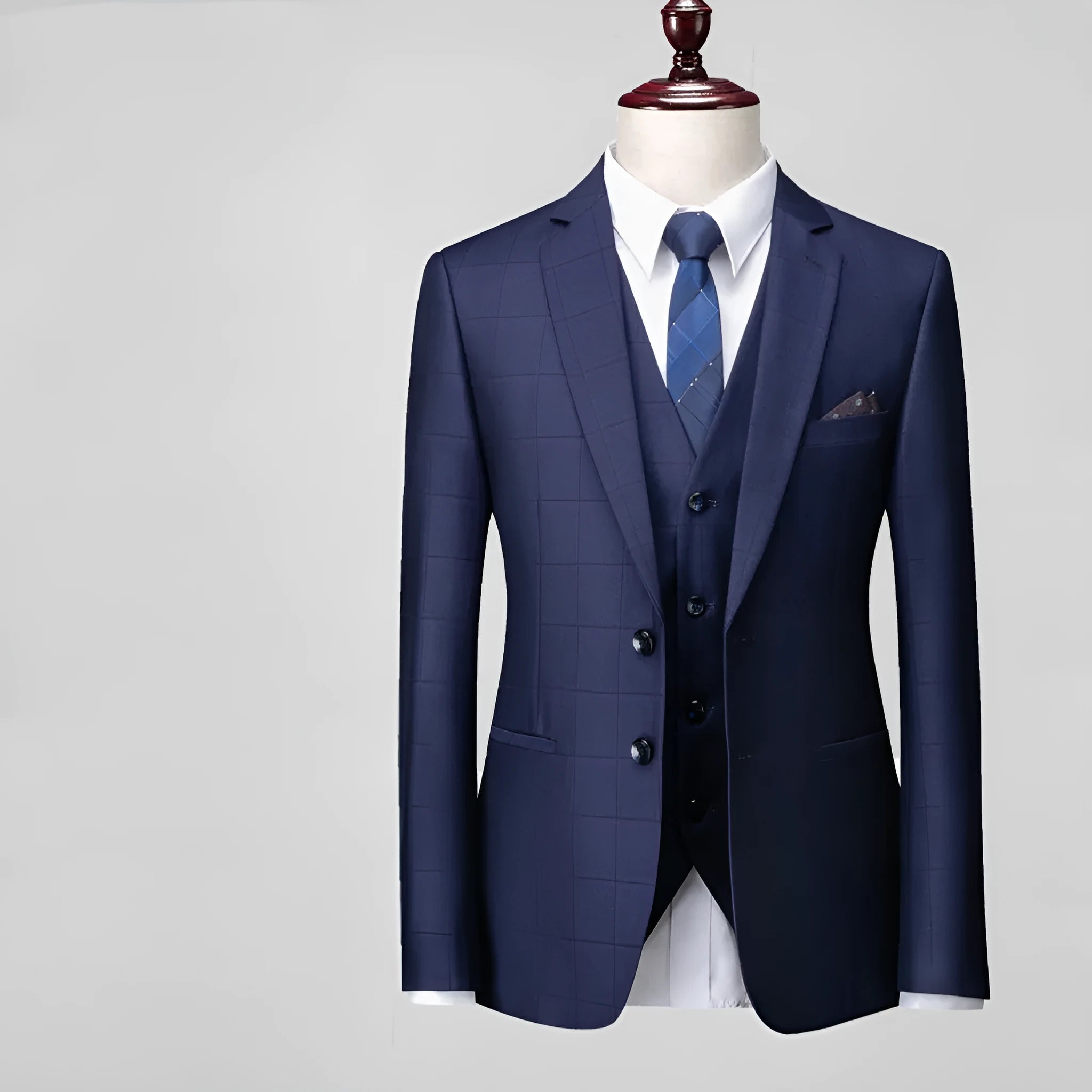 Men's navy blue slim fit three-piece suit with jacket, vest, and trousers on hanger