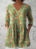 A woman modelling a loose-fitting, printed wave-pattern dress with 3/4 sleeves.