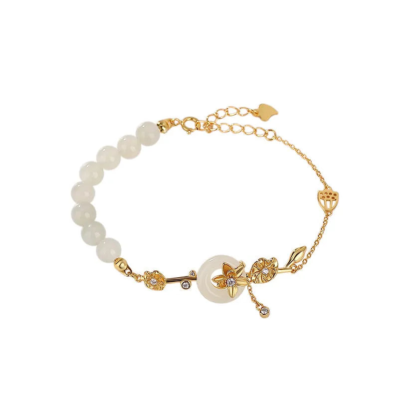 Women's 925 silver bracelet with inlaid Hetian jade centrepiece and ornate lotus peace buckle design.