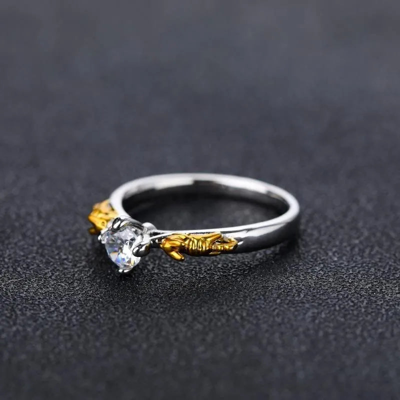 Detailed copper crown ring with crystal accents on a finger, showing black gold and copper finish options.