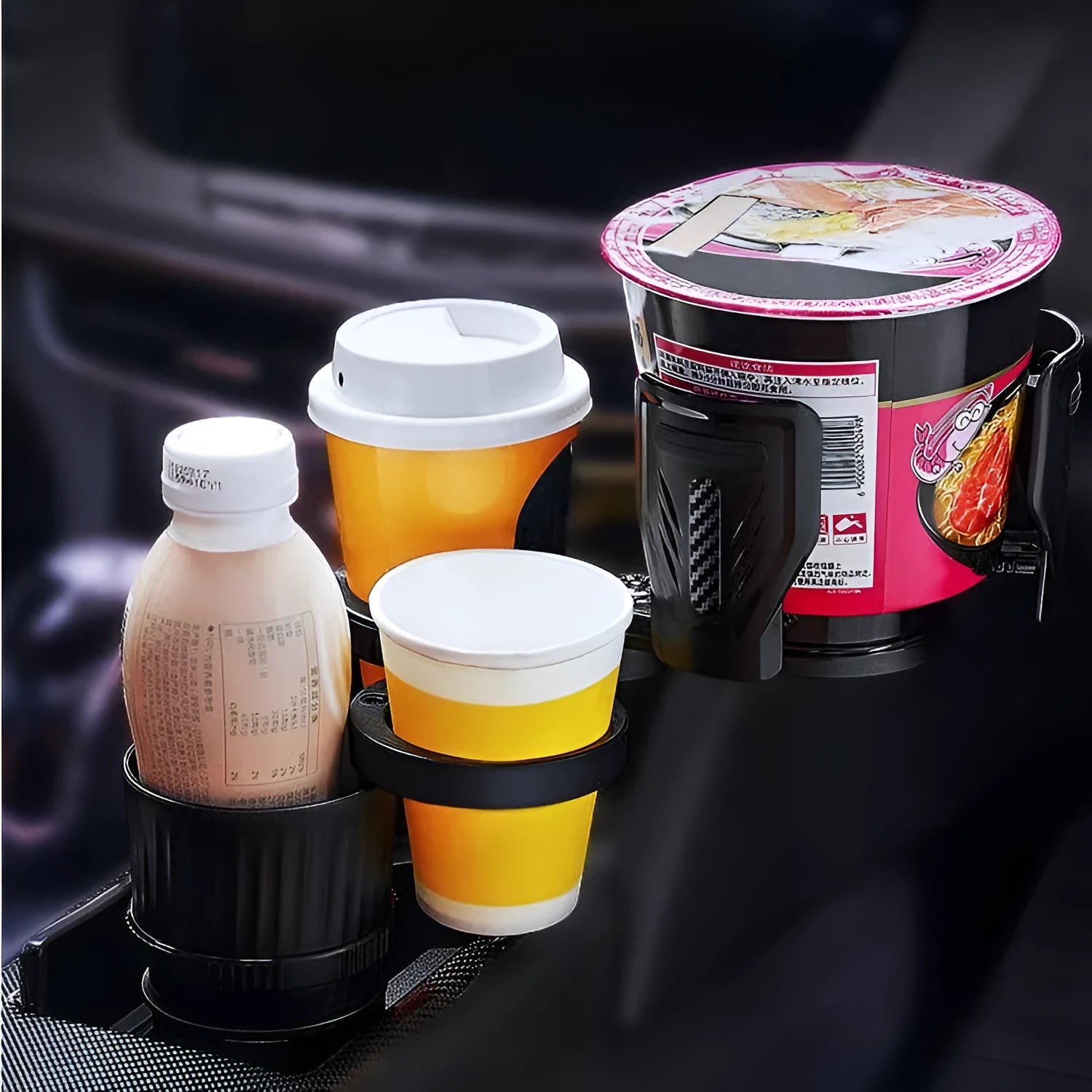 Black carbon fibre car cup holder with a retractable base on a car centre console.