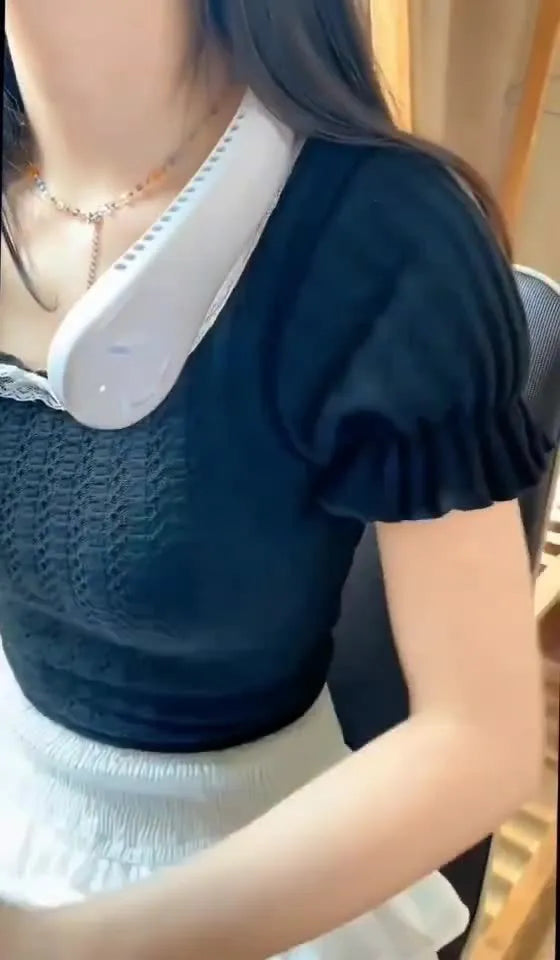 White portable bladeless neck fan being worn, showing its flexible band and streamlined air outlet.