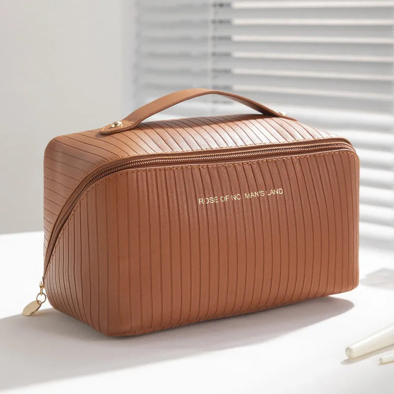 Vertical pattern cubic PU makeup bag in beige, showing large capacity for travel storage.