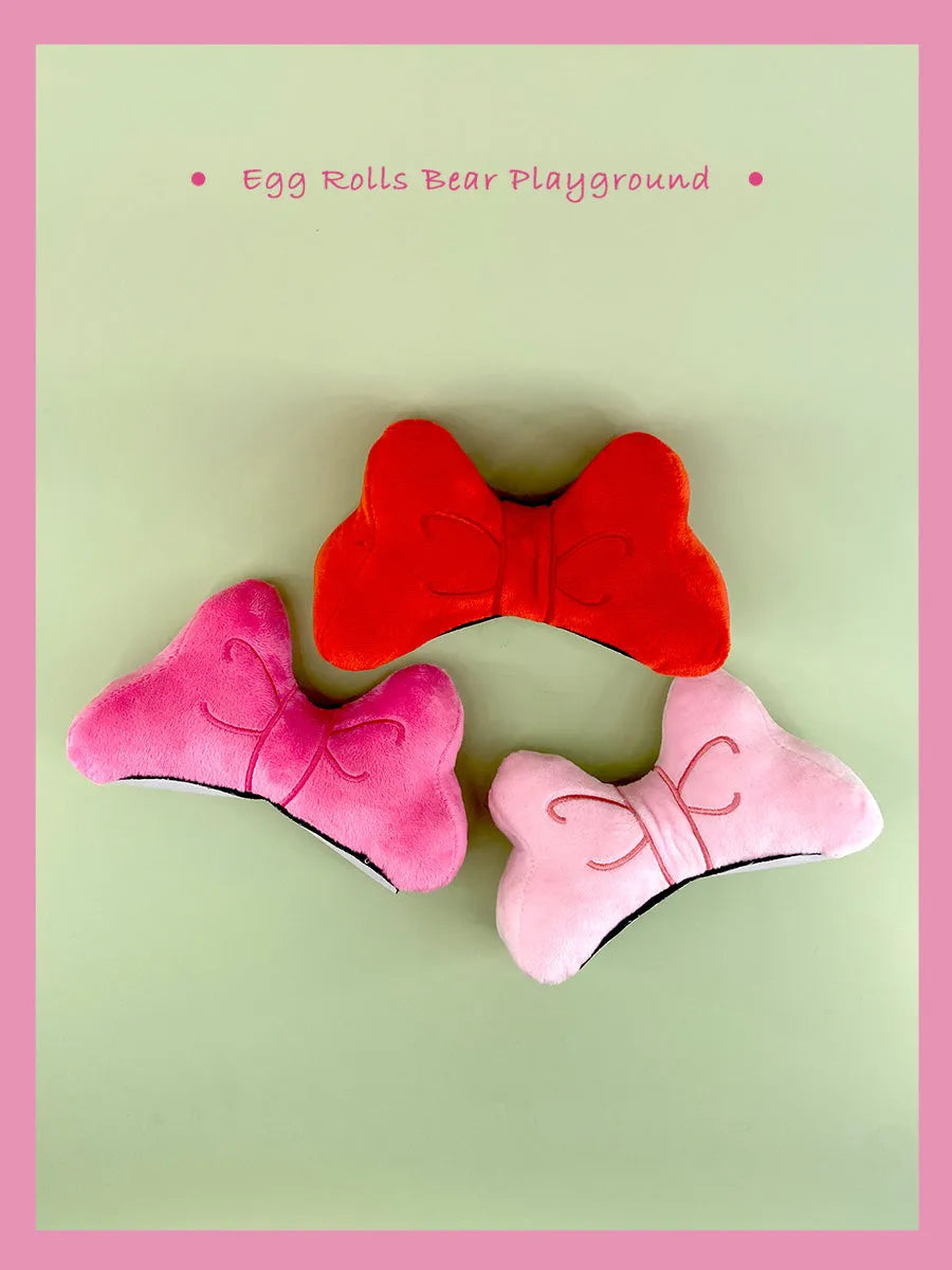 Soft plush bow decoration for helmets in red, peach pink, and rose pink colour options.