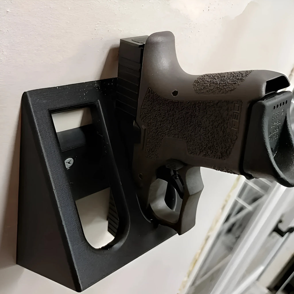 Black punk-style plastic pistol display stand measuring 10.85 by 7.6 centimetres.