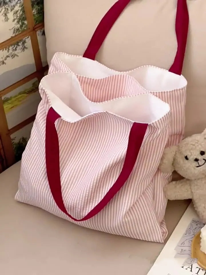 Cotton canvas multi-layer tote shoulder bag in plaid or striped pattern options with wide straps.