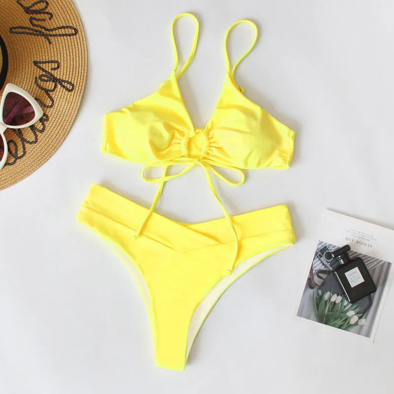 Women's solid colour bikini with a tied bow detail on the split front, shown in multiple colour options.