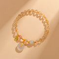 Gold rutilated quartz geometric crystal bracelet with peace buckle safety clasp and pendant charm