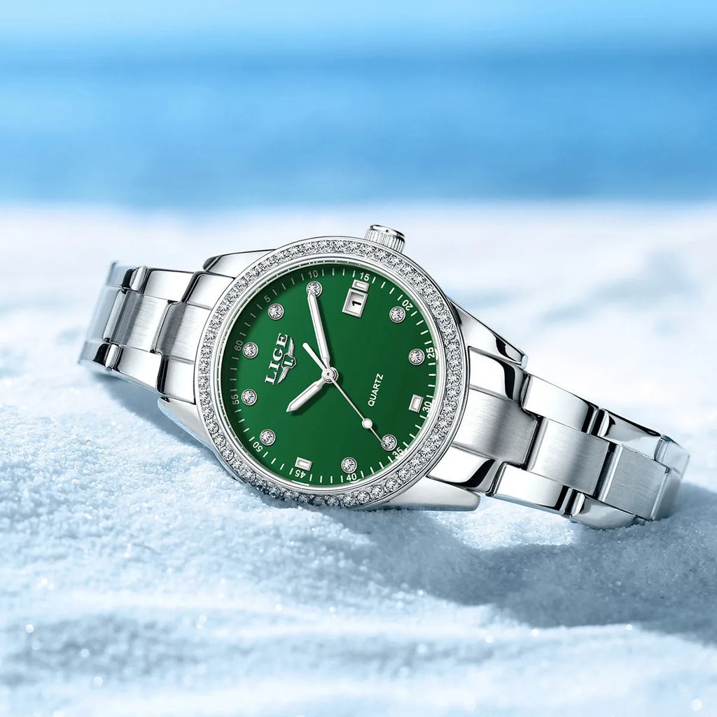 Silver fashion quartz watch with diamond bezel and round white dial on a coloured strap.