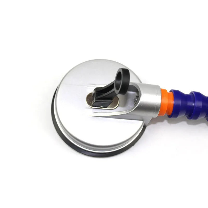 Blue car dent repair tool with suction cup and adjustable bracket on a metal car panel