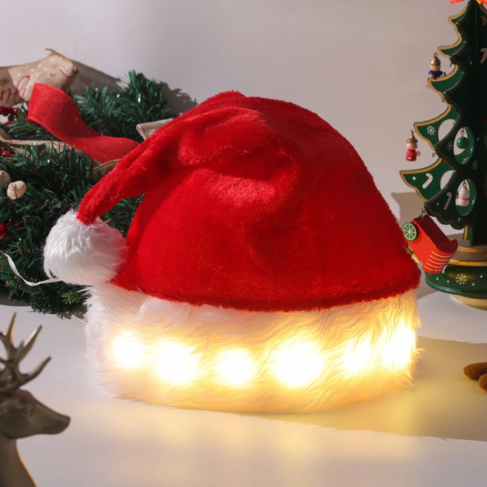 Red and white plush Santa hat with twinkling LED lights glowing in Christmas colours