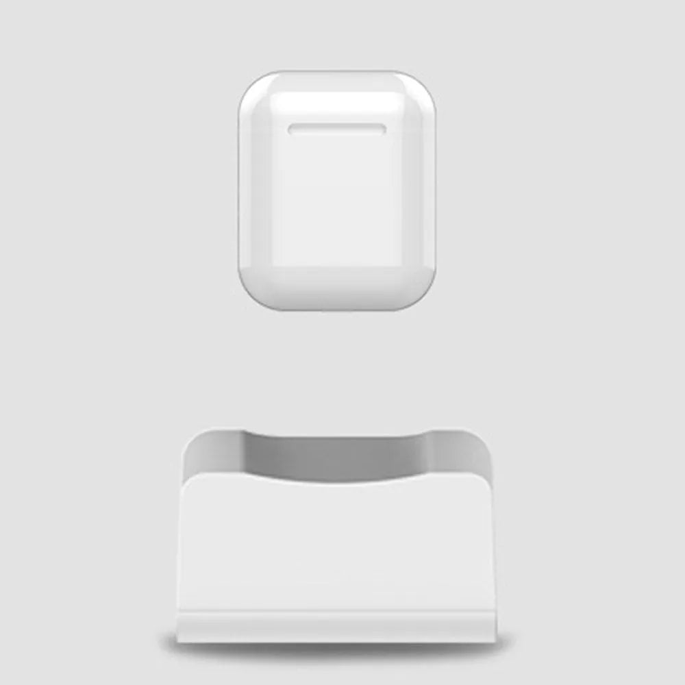 White headphone charging base with minimalist design on desk surface
