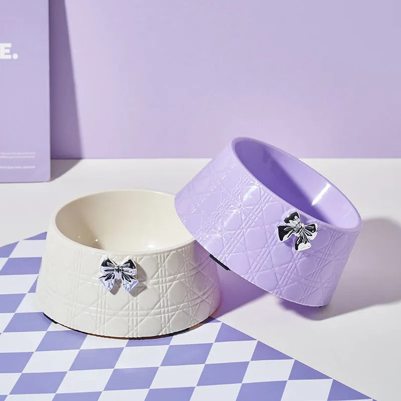Ceramic pet bowl with diamond pattern and bowknot design in black, purple, and white options