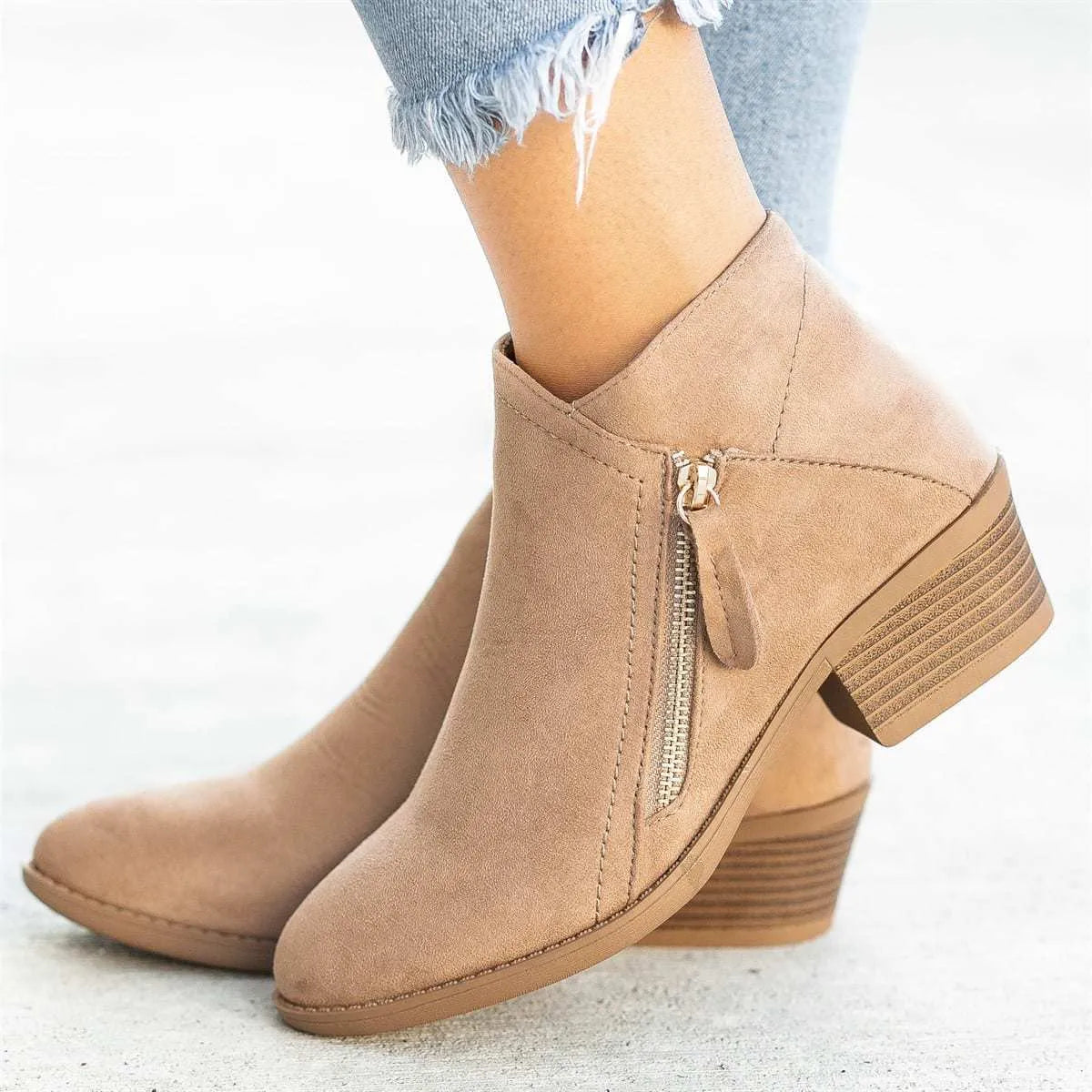 Women's blue suede ankle boots with side zip and chunky heel on white background