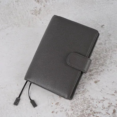 A6 leather notebook with lychee pattern cowhide cover showing loose-leaf binding in three colour options