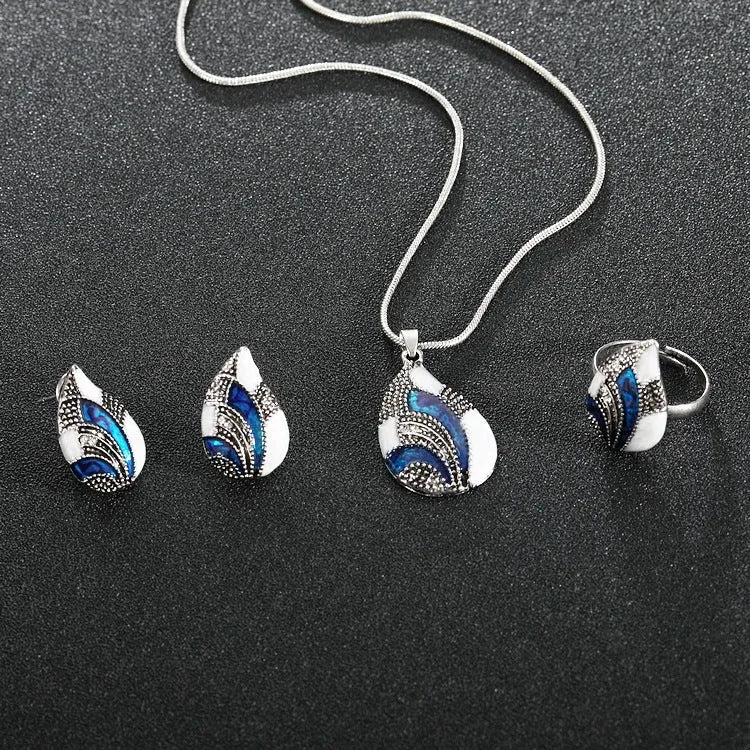 Gold water drop jewellery set with necklace, earrings, and ring on white background