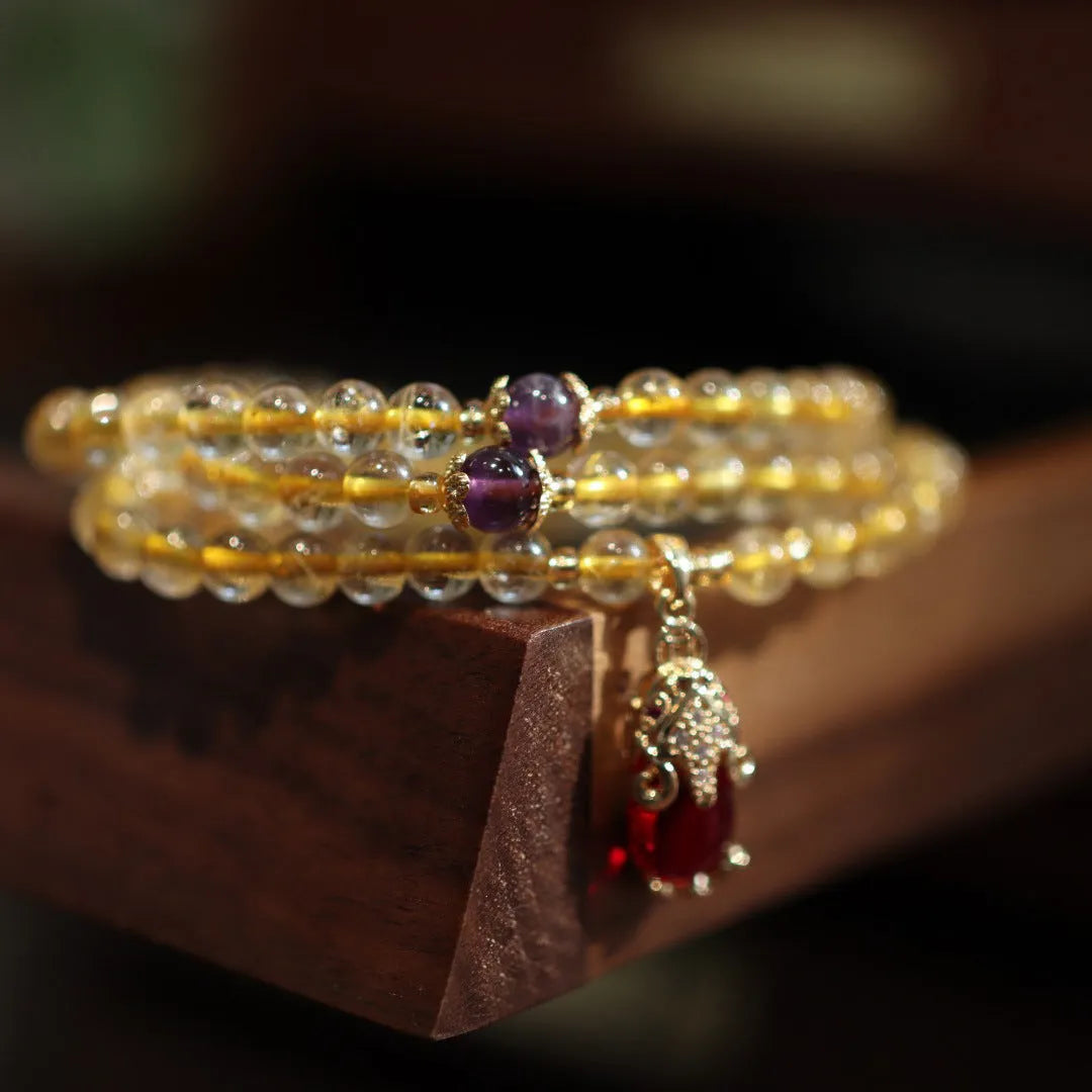 Brazilian rutilated quartz bracelet with Chinese style three-ring gold design in natural gold colour