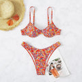 Red women's swimsuit with small floral pattern, high waist design, and side splits on legs