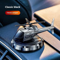 Silver metal solar-powered helicopter car air freshener with spinning blades on a dashboard.