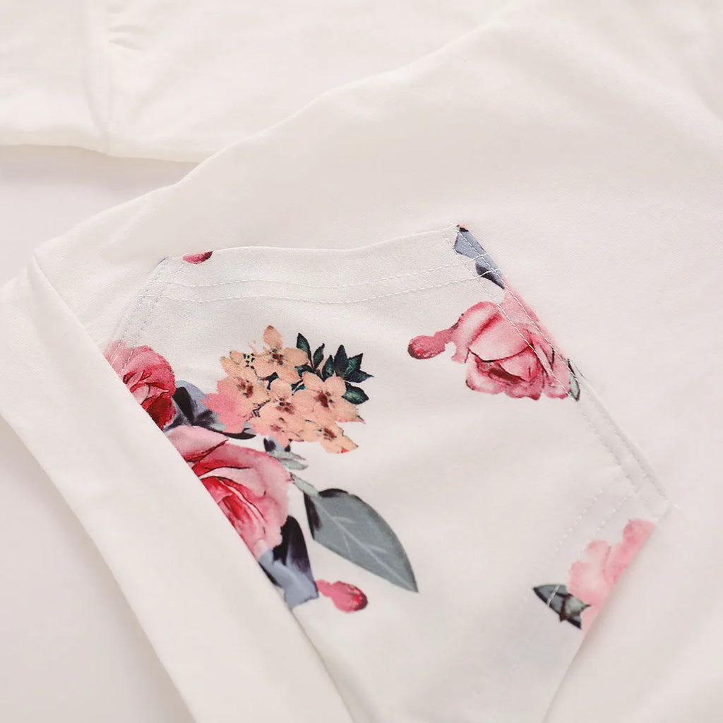 White cotton hooded tracksuit set for a baby girl, showing long sleeves and full-length trousers.