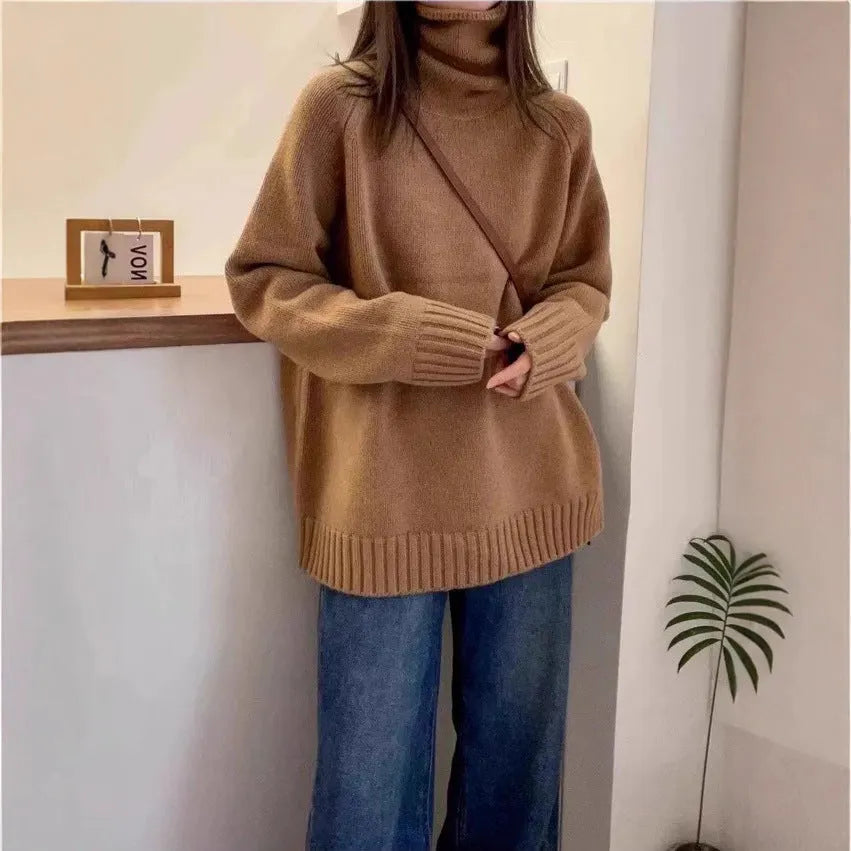 Women's loose grey turtleneck sweater with a thick curling pile collar and 3D pattern texture.