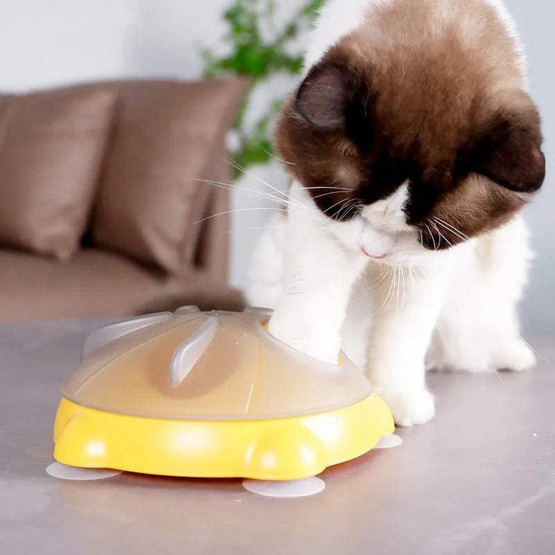 Yellow interactive pet puzzle feeder bowl with ridges and treat compartments on a white background.