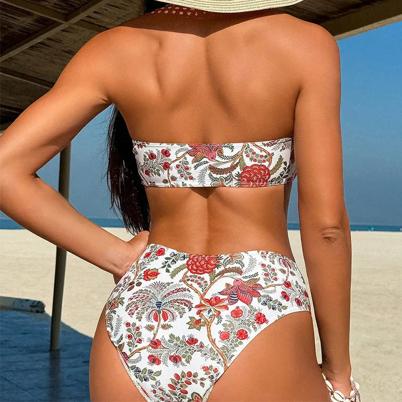 Close-up view of a women's printed bandeau swimsuit top and high-waisted shorts set laid flat.