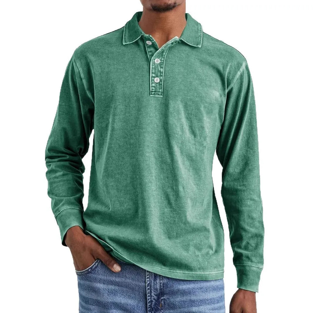 Man wearing a grey washed cotton long sleeve polo shirt with a lapel collar and subtle distressing.