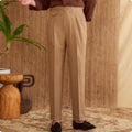 Man wearing slim fit wrinkle resistant business casual trousers in a light brown colour.