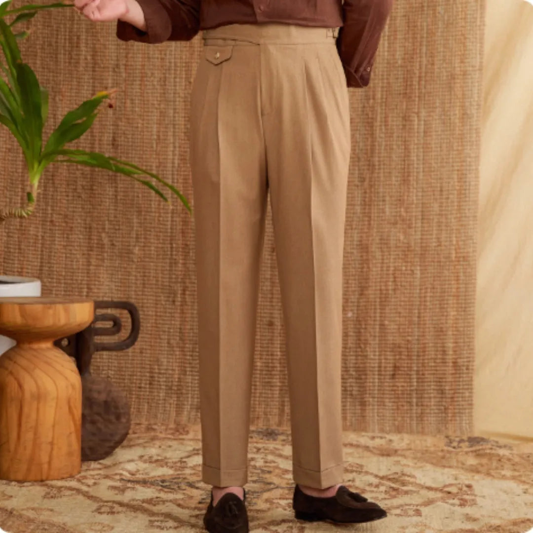 Man wearing slim fit wrinkle resistant business casual trousers in a light brown colour.