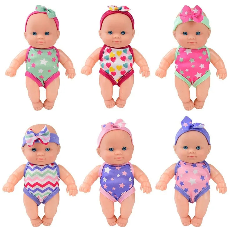 Vinyl baby figurine doll in display with colour variations and measurement scale