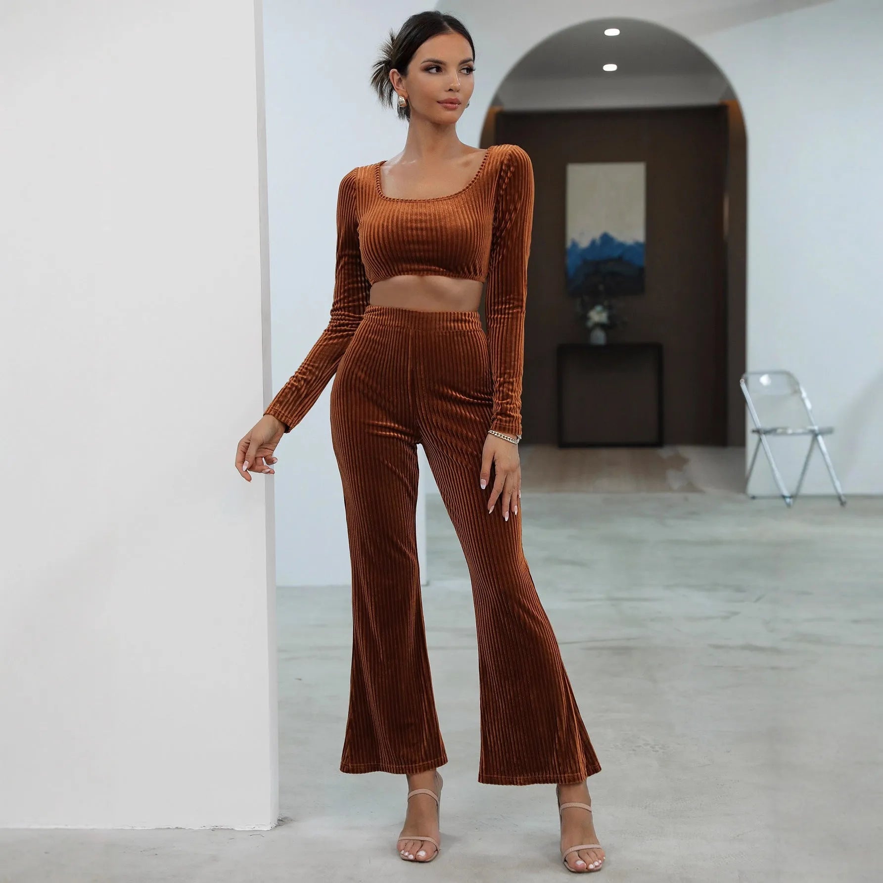 Caramel-coloured women's long sleeve knit sweater and matching trousers laid flat, a two-piece loungewear set.