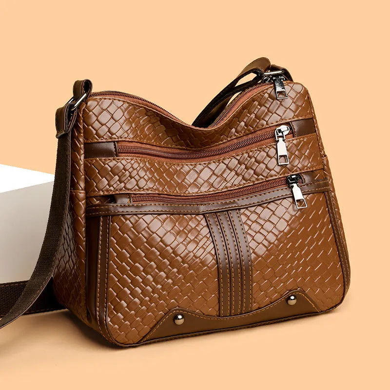 Woven PU messenger bag with single shoulder strap showing horizontal square shape and multiple compartments