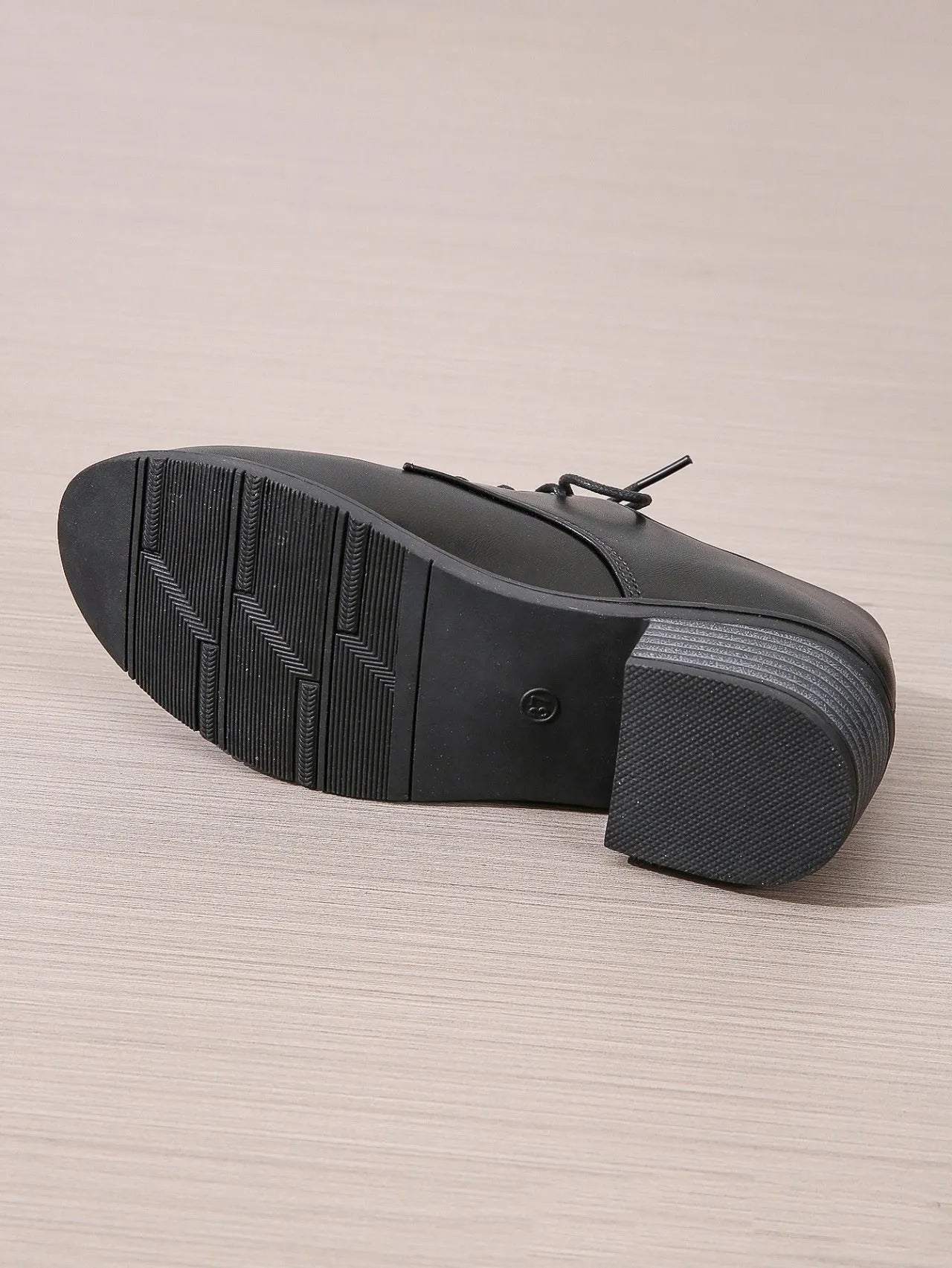 Black women's work shoes with a chunky heel, round toe, and low top design on a rubber sole.