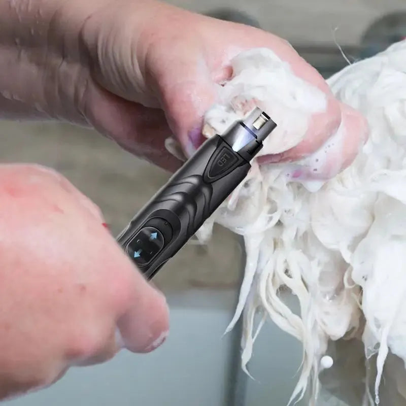 Black rechargeable dog nail grinder with LED light, shown with its 2-speed settings.