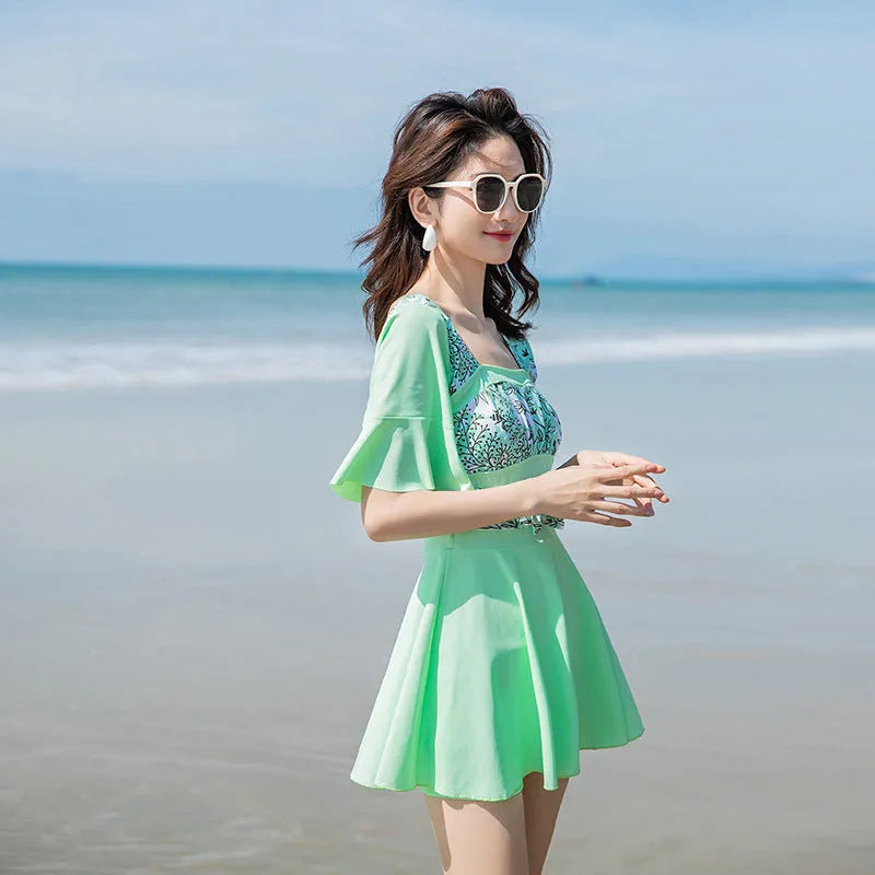 Blue and green women's one-piece swimsuit with seaside print pattern