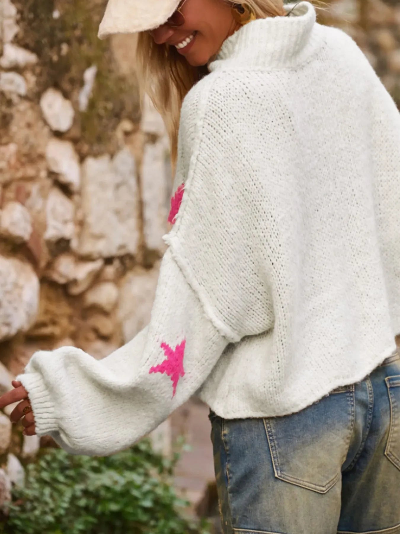 White women's loose turtleneck pullover with a thick imitation velvet texture and a five-pointed star pattern on the front.