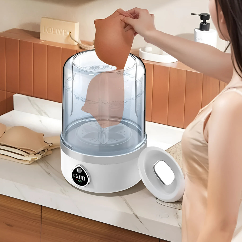 White portable mini washing machine with USB cable on a countertop.