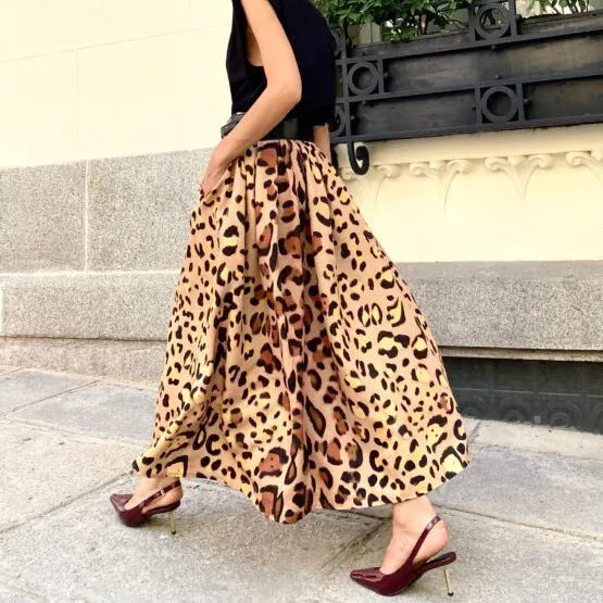 Brown leopard print women's A-line long skirt with a deep, flowing hem on a hanger.