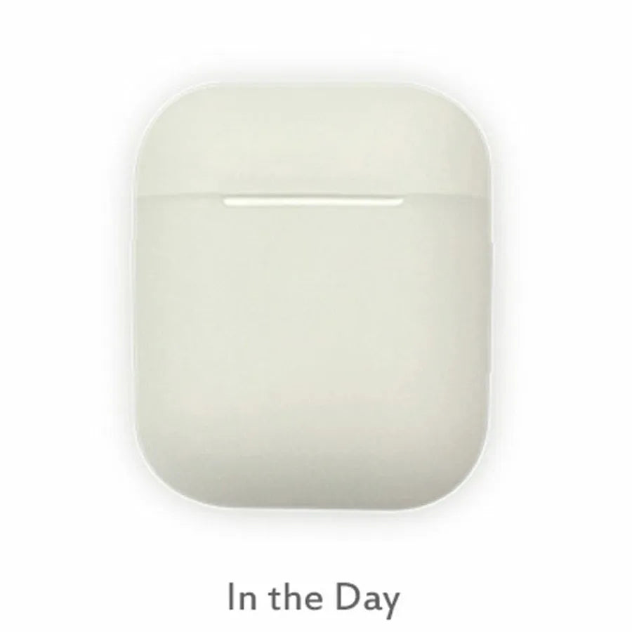 Glow-in-the-dark silicone flip-top protective case for Apple AirPods on a dark background