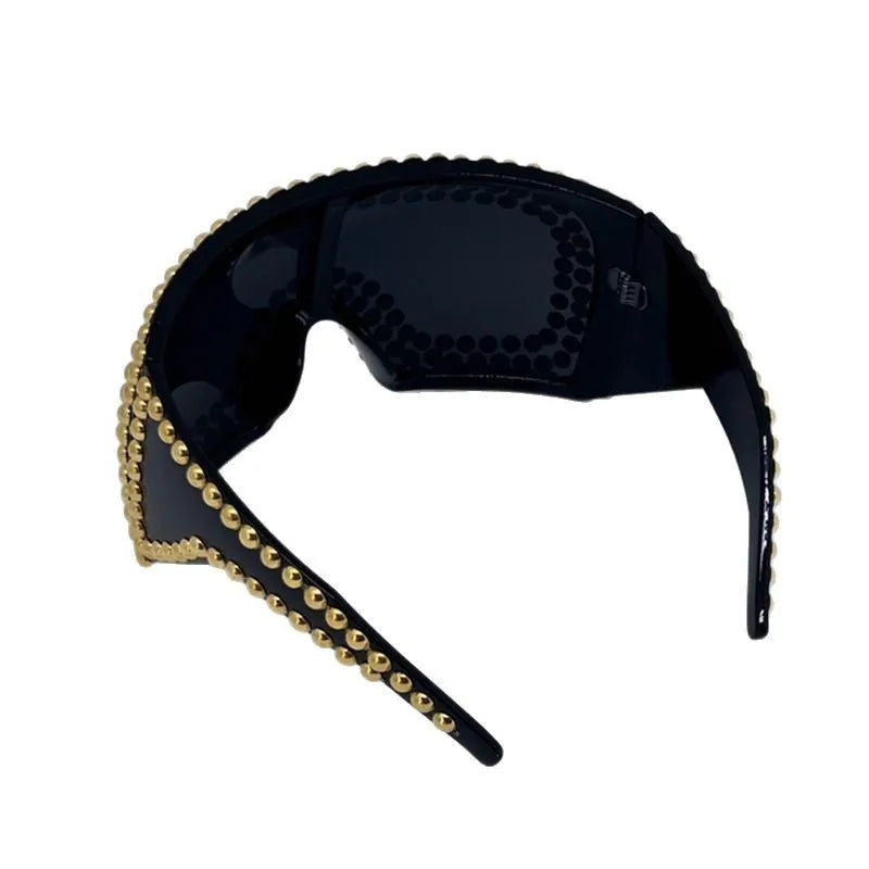 Men's silver square sunglasses with large rim, rivet details on arms, on a plain background.