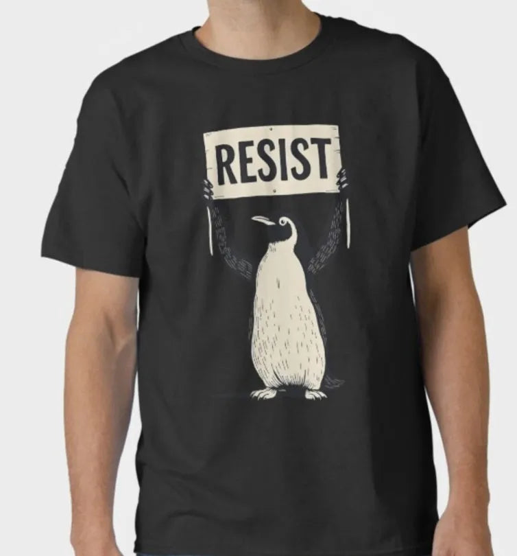 Straight cut loose fit cotton t-shirt in black on a hanger, showing round neck and short sleeves.