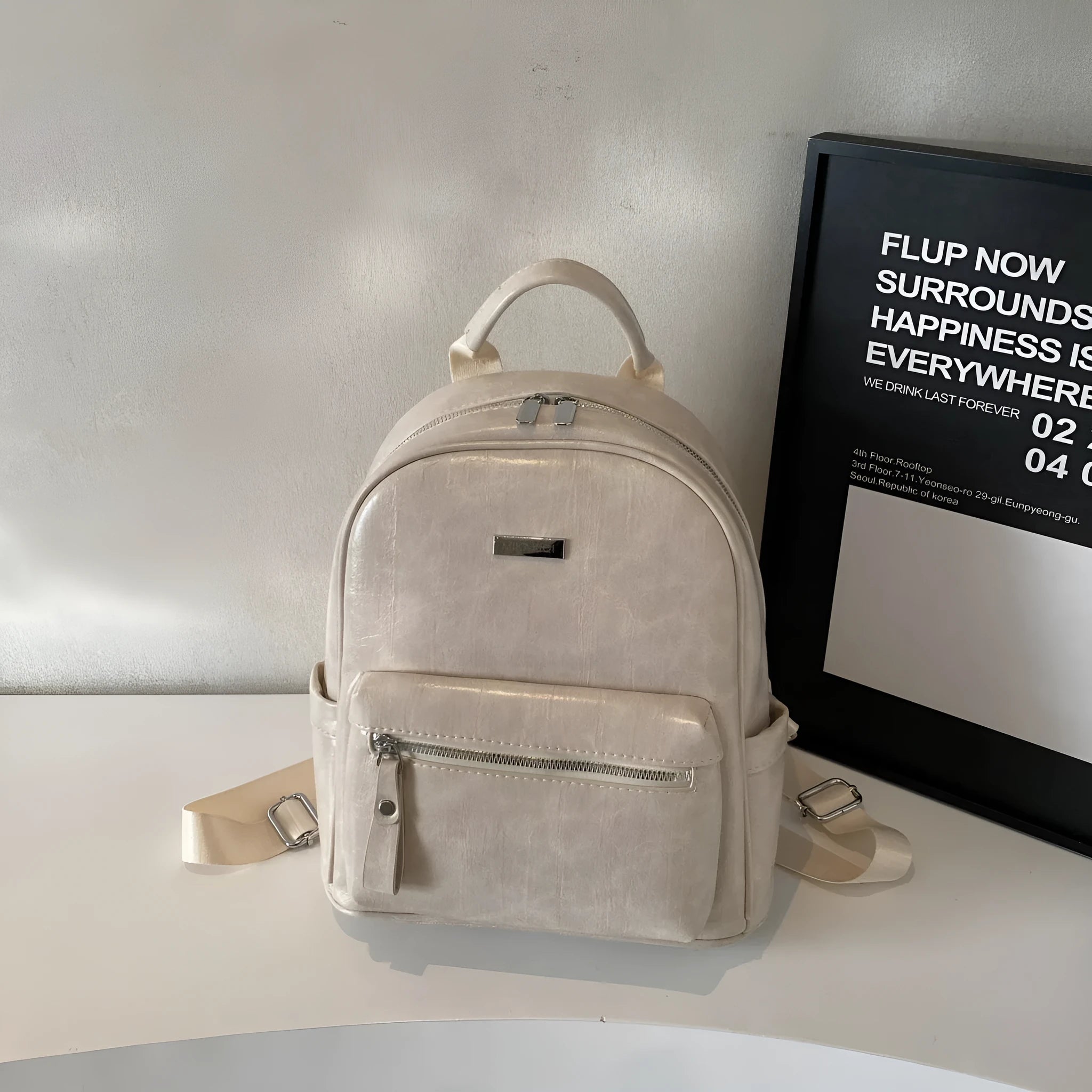 Simple fashion trendy ladies travel backpack in waterproof PU with sandwich pocket, available in multiple colours